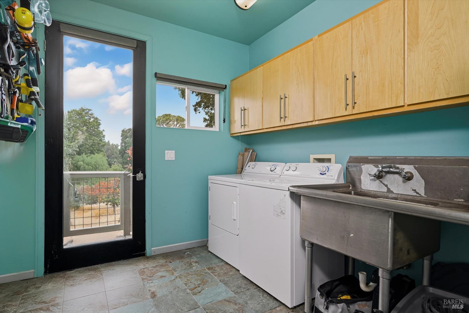 31000 Pine Mountain Road Cloverdale, CA 95425 - Photo 43 of 61 Functional laundry room featuring a utility sink, upper storage cabinets, and convenient exterior access.