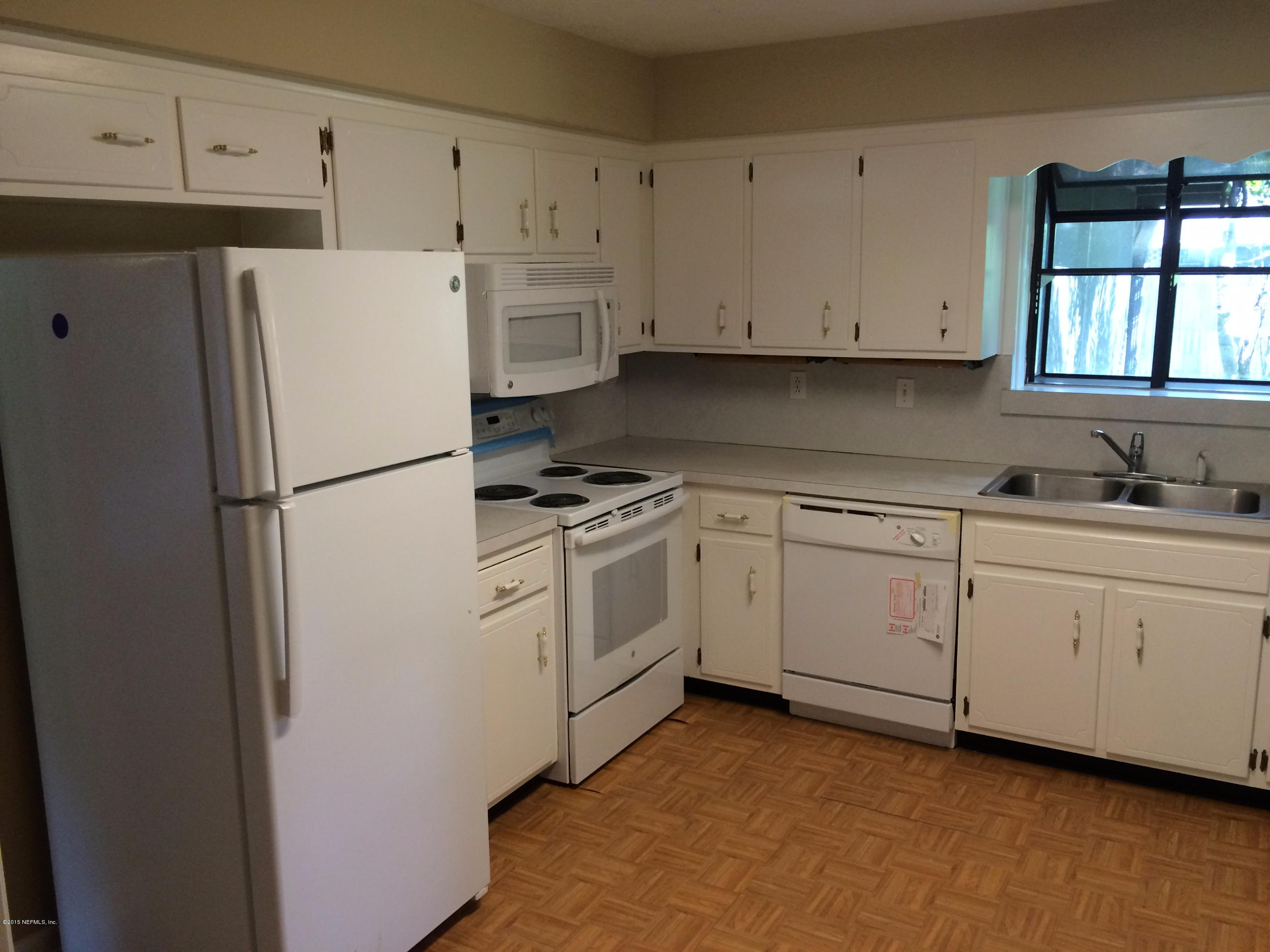 5471 Weaver Road Orange Park, FL 32073 - Photo 11 of 22 a kitchen with white cabinets and white appliances