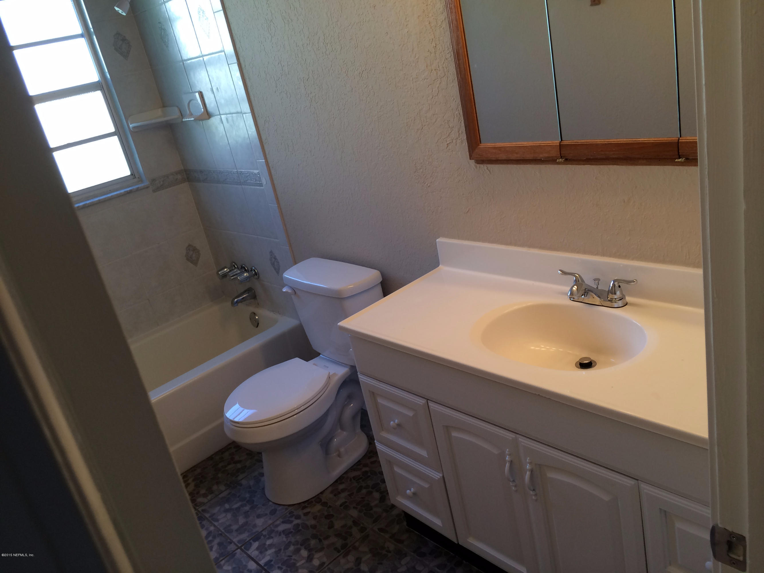 5471 Weaver Road Orange Park, FL 32073 - Photo 17 of 22 a white toilet sitting next to a bathroom sink