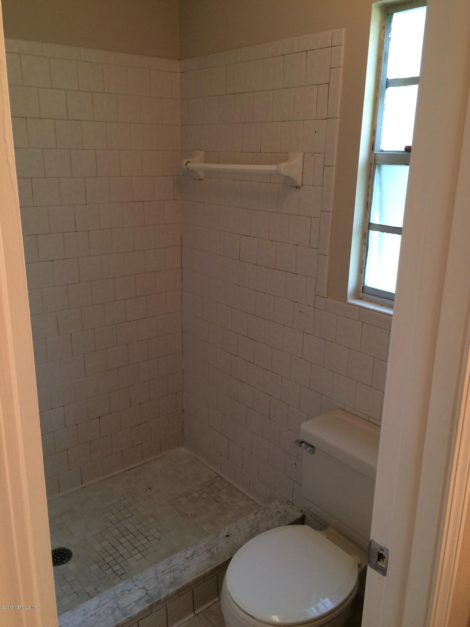 5471 Weaver Road Orange Park, FL 32073 - Photo 20 of 22 a white toilet sitting next to a window