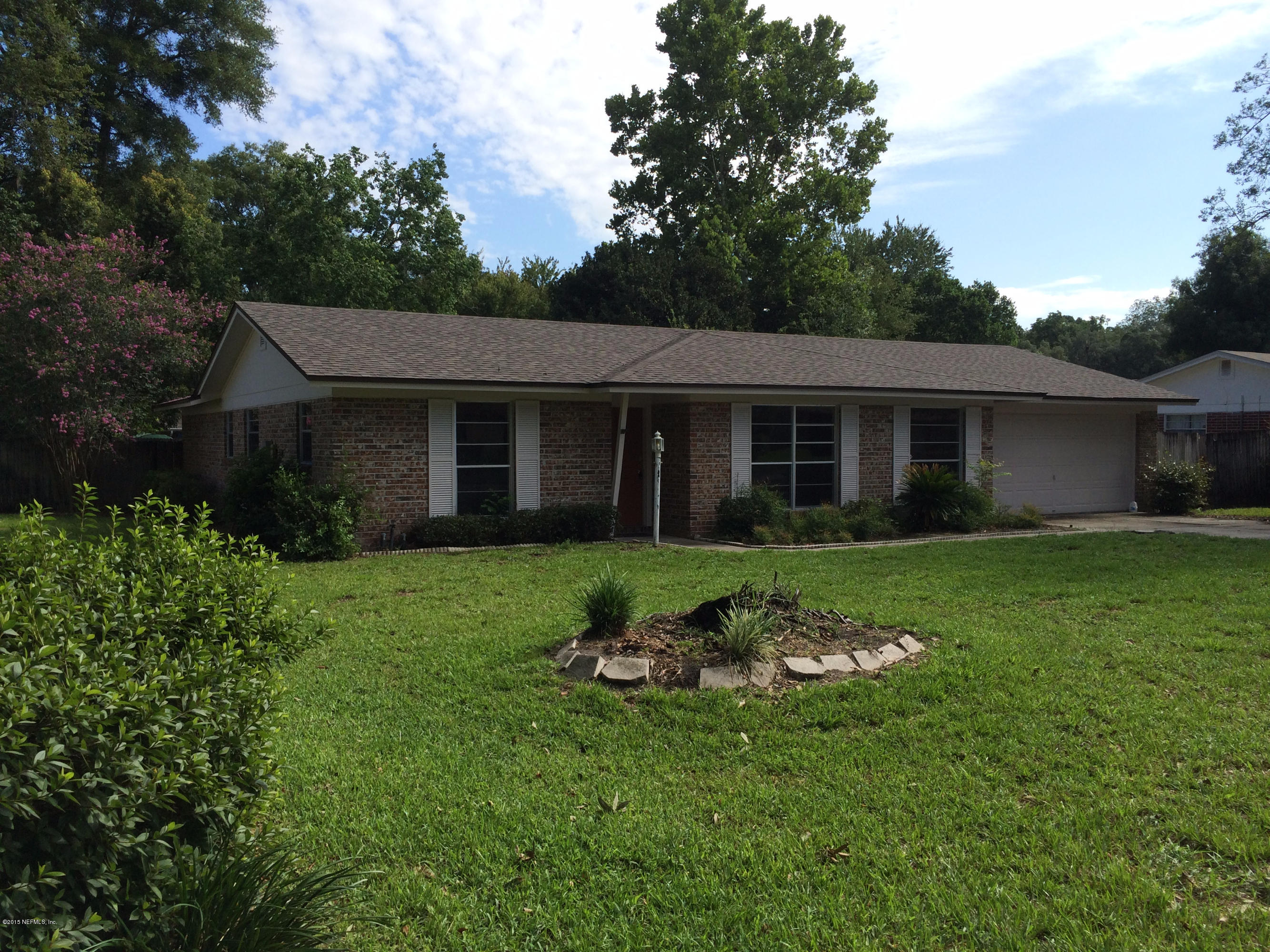 5471 Weaver Road Orange Park, FL 32073 - Photo 2 of 22 a front view of a house with a garden