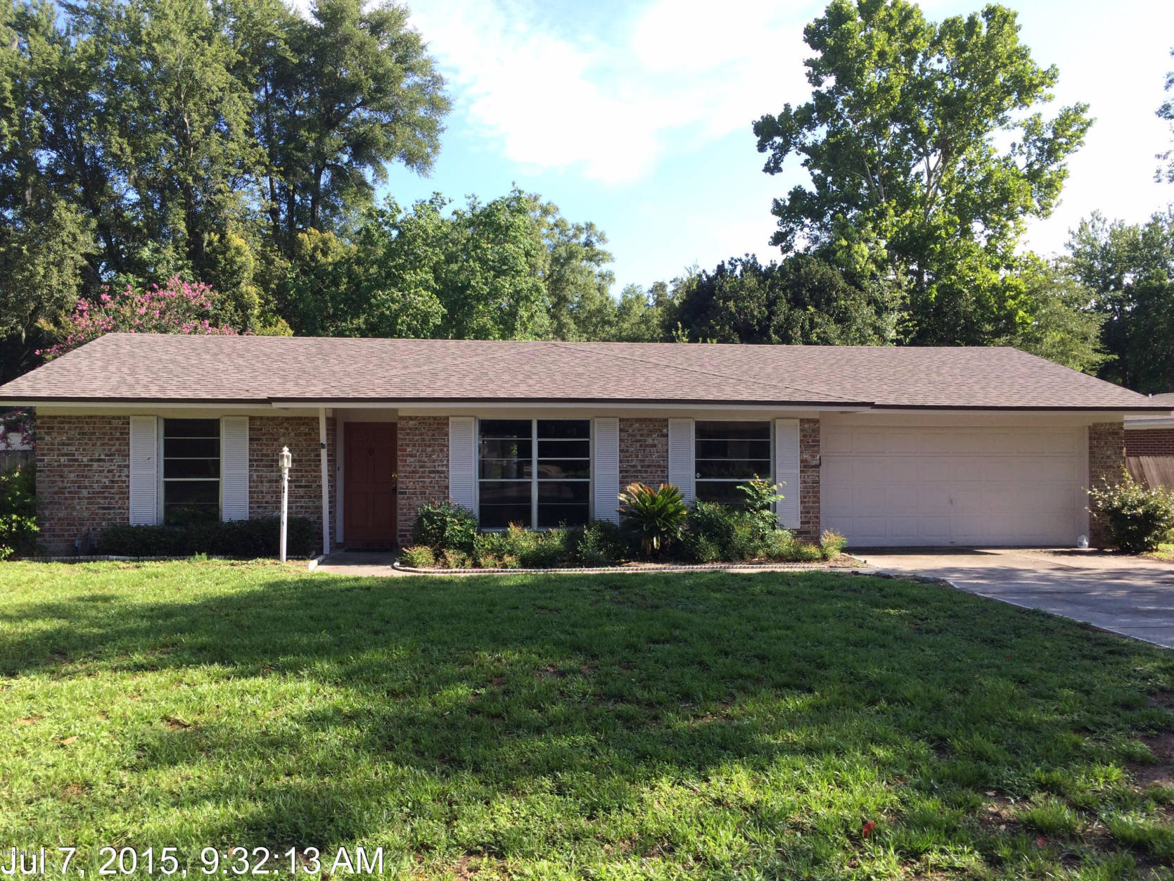 5471 Weaver Road Orange Park, FL 32073 - Photo 4 of 22 a front view of a house with a garden and porch