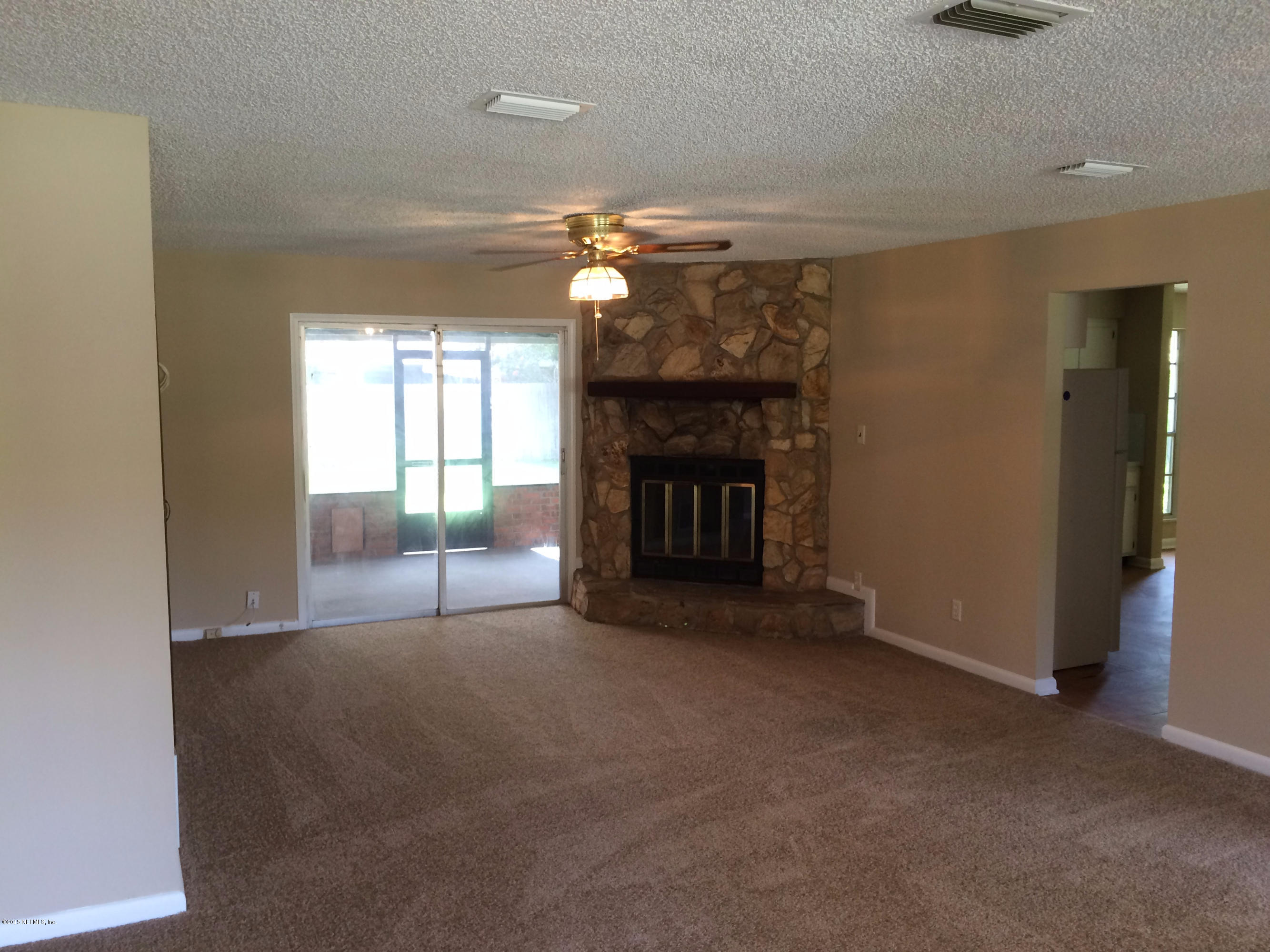 5471 Weaver Road Orange Park, FL 32073 - Photo 5 of 22 a view of empty room with fireplace and fan