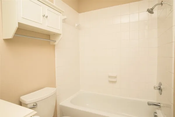 a white bath tub sitting next to a white toilet