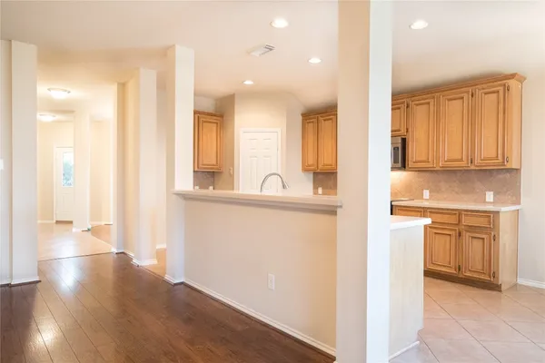 a view of a kitchen cabinets and wooden floor