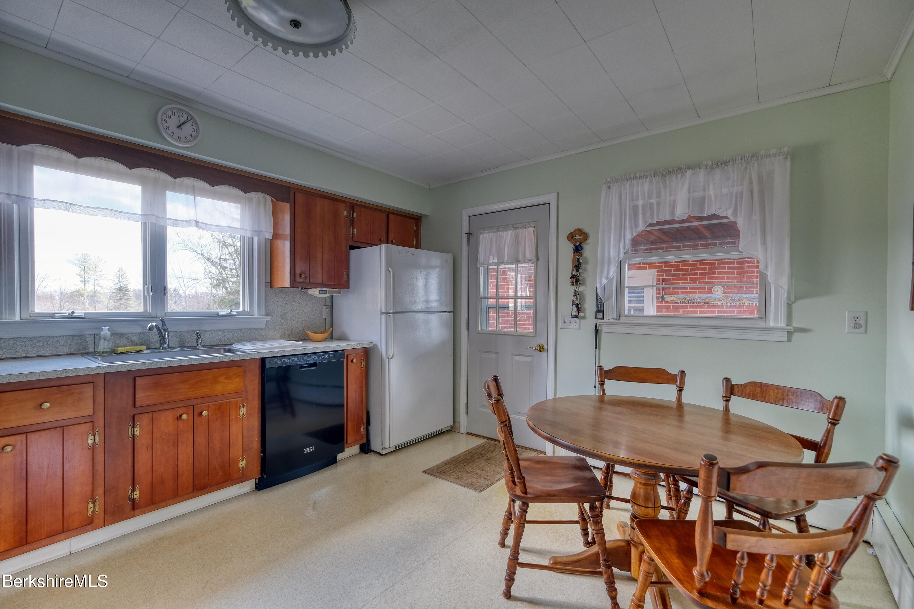 237 Eleanor Road Pittsfield, MA 01201 - Photo 10 of 30 a dining room with a wooden table and chairs