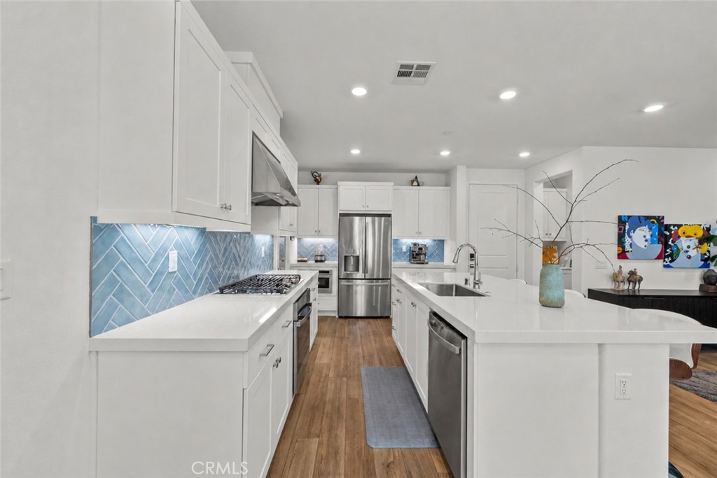 1663 Rosewell Road West Covina, CA 91791 - Photo 3 of 45 a kitchen with a sink stove and cabinets