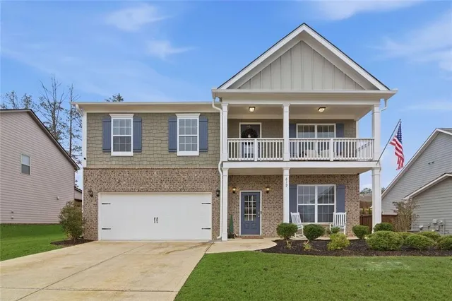 a front view of a house with a yard and porch