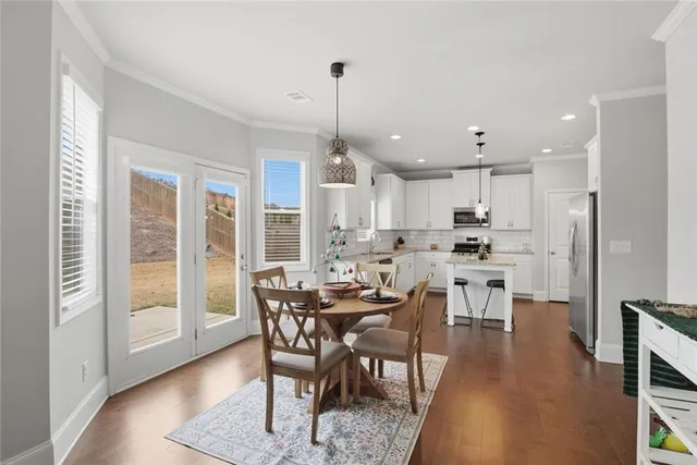 a dining room with furniture and window