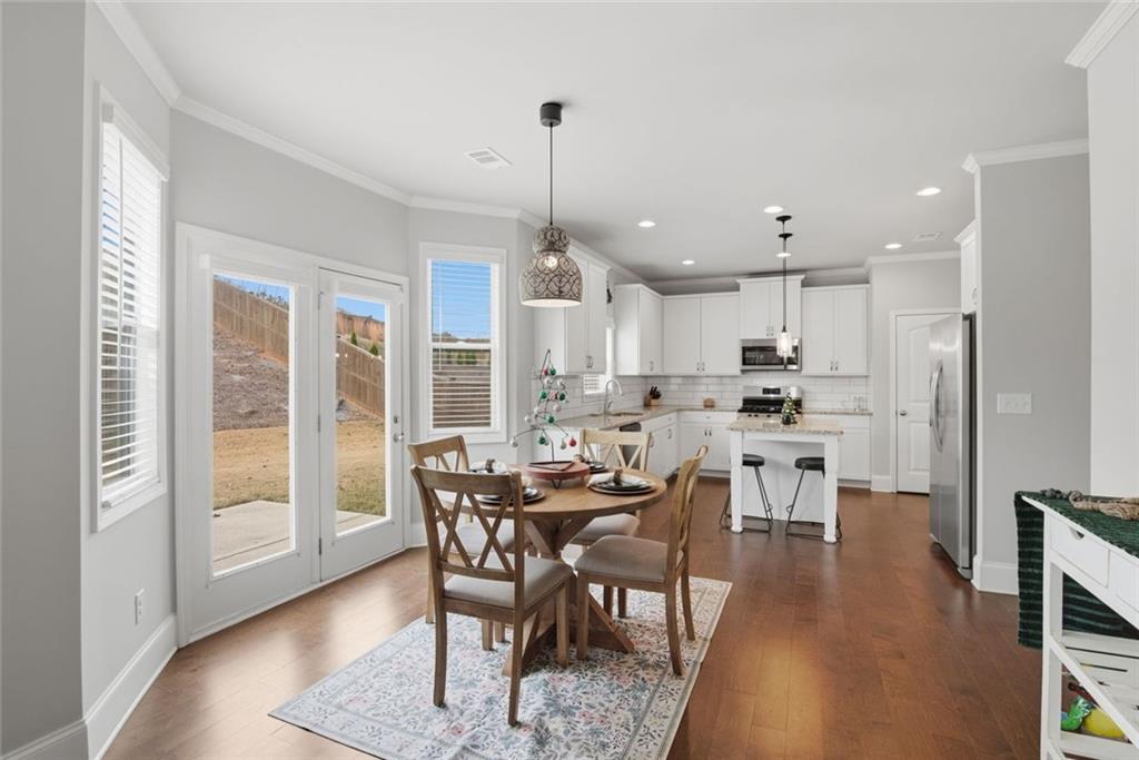 619 Little Bear Loop Canton, GA 30114 - Photo 14 of 39 a view of a dining room with furniture window and wooden floor