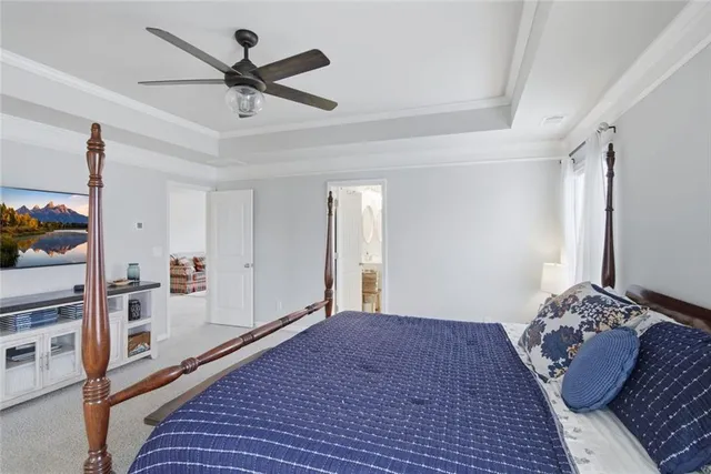 a bedroom with a bed a table and a chandelier