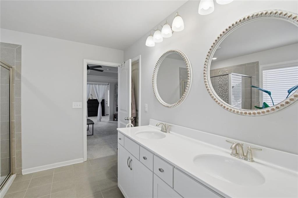 619 Little Bear Loop Canton, GA 30114 - Photo 24 of 39 a en suite bathroom with a double vanity sink and a mirror