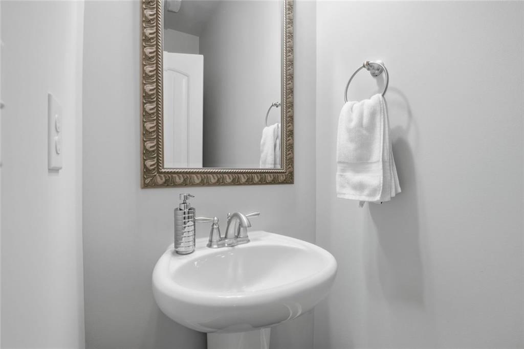 619 Little Bear Loop Canton, GA 30114 - Photo 34 of 39 a bathroom with a sink and a mirror