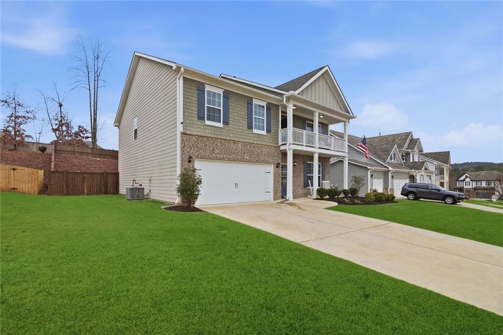 619 Little Bear Loop Canton, GA 30114 - Photo 36 of 39 a front view of a house with a yard and garage