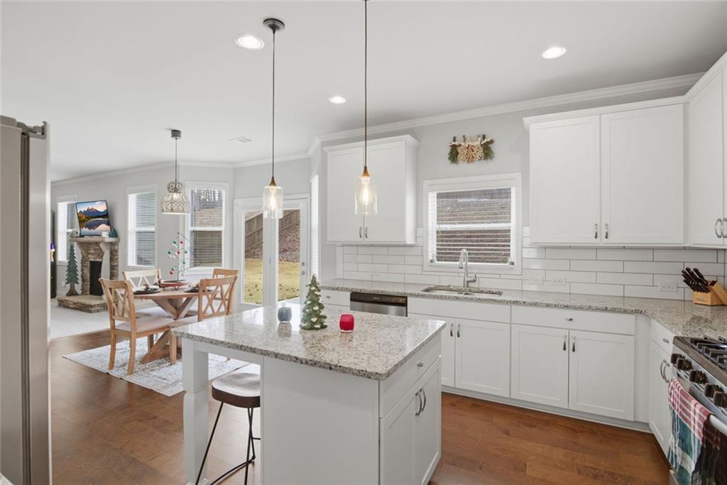 619 Little Bear Loop Canton, GA 30114 - Photo 10 of 39 a kitchen with a sink stove and cabinets