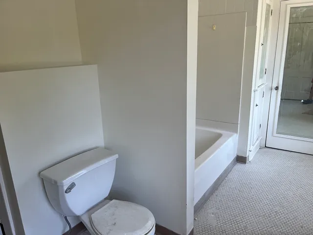 a white toilet sitting next to a bathroom sink
