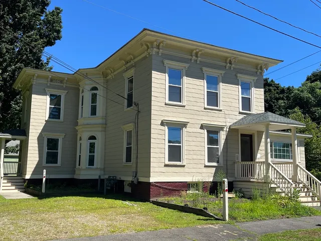 a front view of a house with a yard