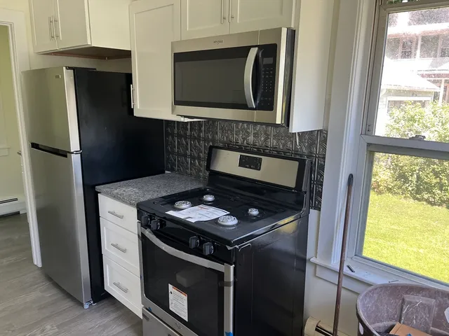 a stove top oven sitting inside of a kitchen