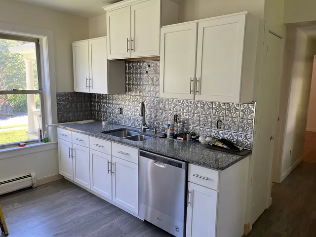 a kitchen with sink and cabinets