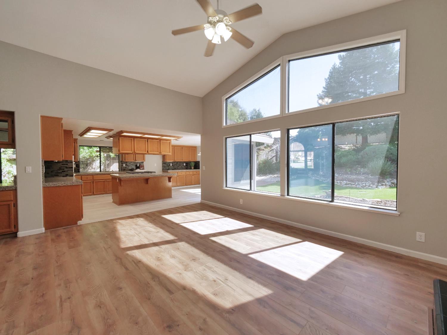 11864 South Carson Way Gold River, CA 95670 - Photo 18 of 69 a view of an empty room with a window and wooden floor
