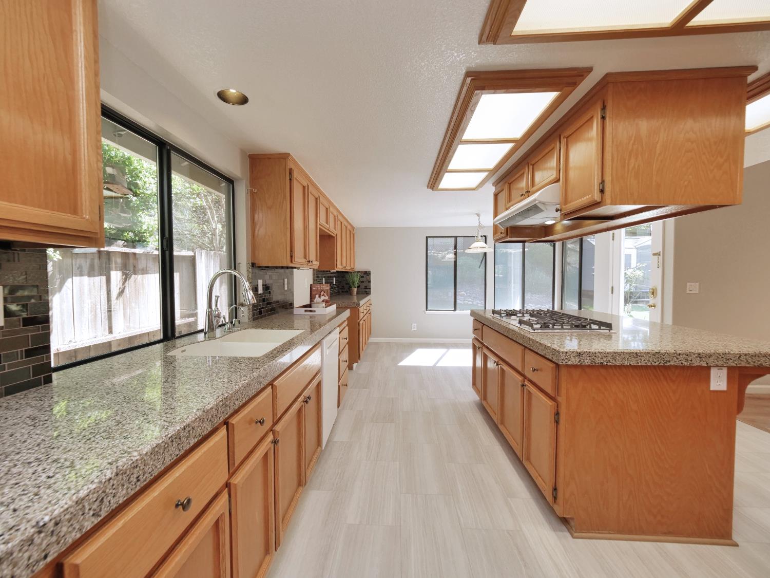 11864 South Carson Way Gold River, CA 95670 - Photo 23 of 69 a kitchen with stainless steel appliances granite countertop a sink a stove and a wooden floors