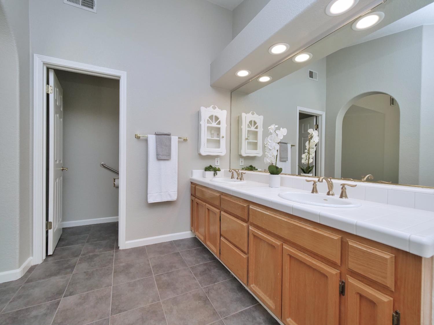 11864 South Carson Way Gold River, CA 95670 - Photo 60 of 69 a spacious bathroom with a granite countertop sink mirror and a
