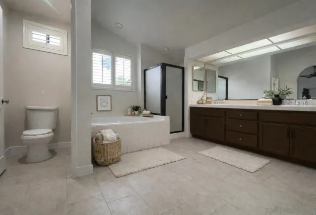 a spacious bathroom with a tub sink and mirror