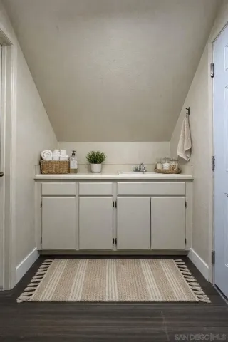 a view of a room with cabinets and washer dryer