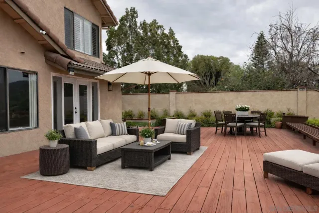 a view of a patio with couches and potted plants