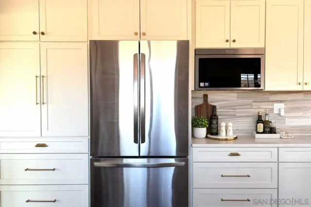 a kitchen with a refrigerator and cabinets