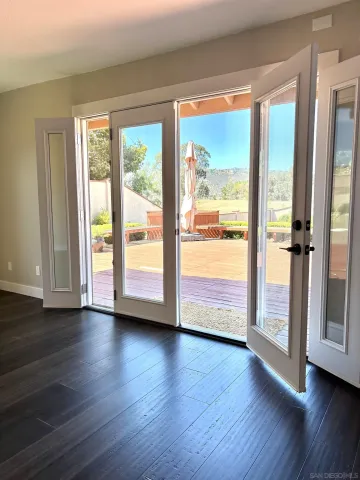 a view of an entryway with wooden floor
