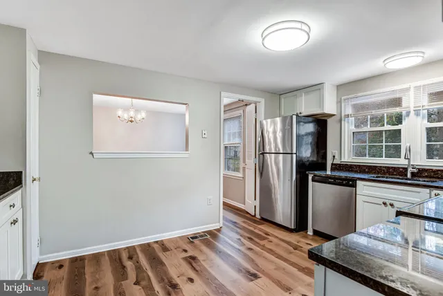 a kitchen with a refrigerator and a sink