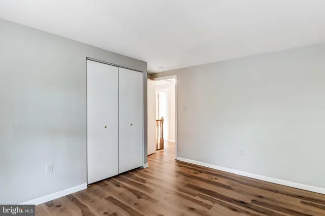 a view of an empty room and wooden floor