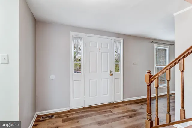 a view of an entryway with wooden floor