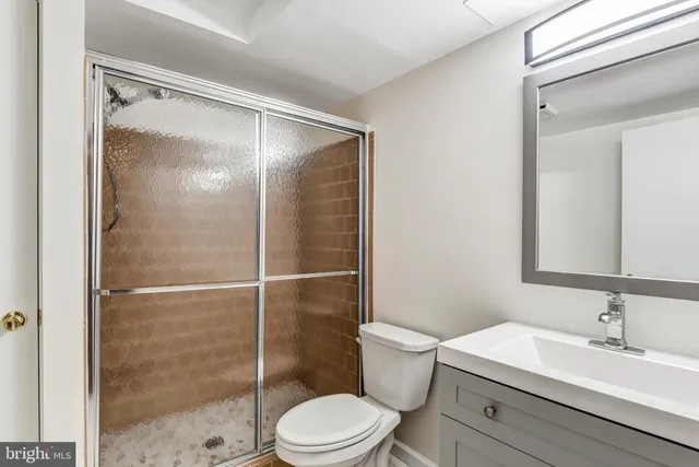 a bathroom with a sink mirror toilet and shower