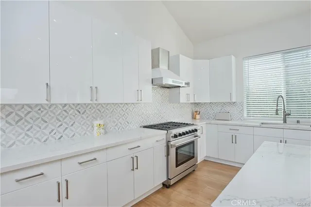 a kitchen with white cabinets and white appliances