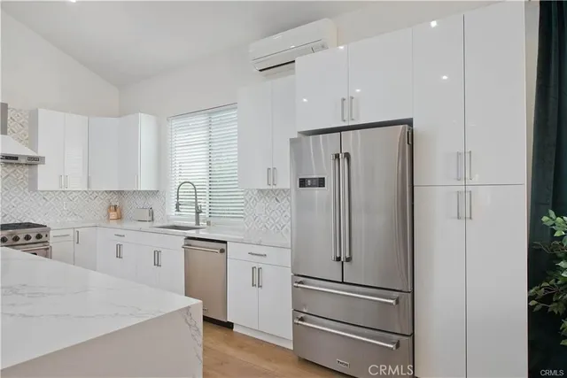 a kitchen with stainless steel appliances a refrigerator sink and cabinets