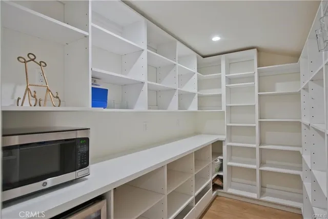 a hallway with cabinets and a fireplace