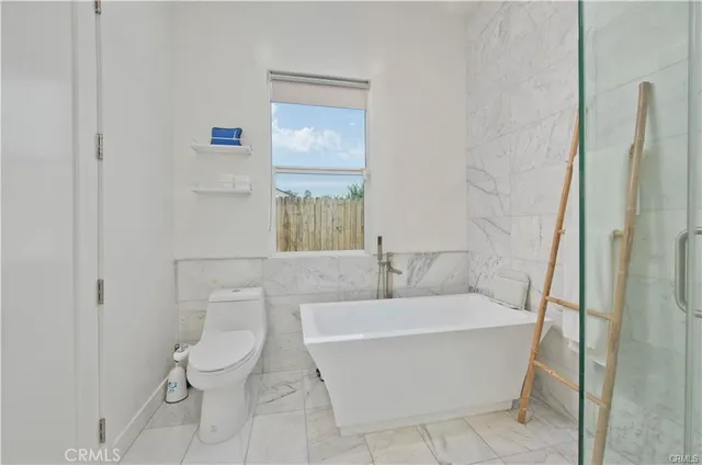 a bathroom with a bathtub and toilet