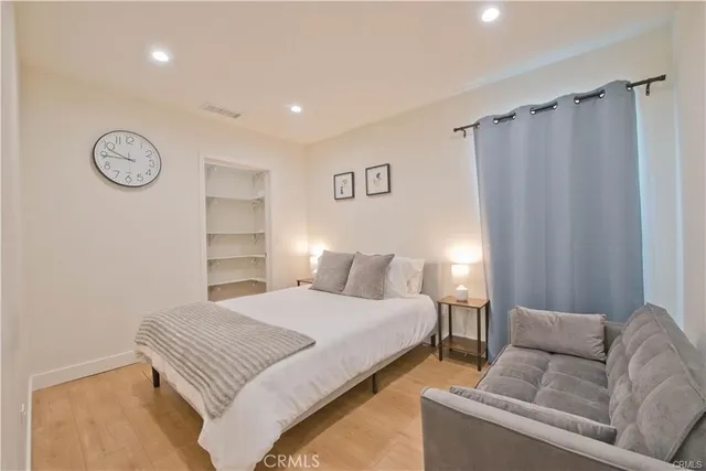 a bedroom with a bed and a couch