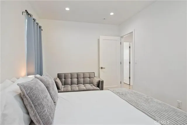 a bedroom with a bed and a window