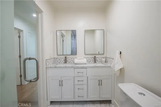 a bathroom with a granite countertop sink a toilet and a mirror