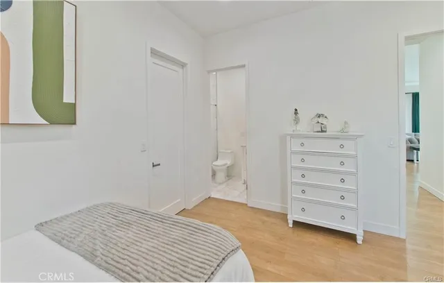 a bedroom with a bed and a mirror