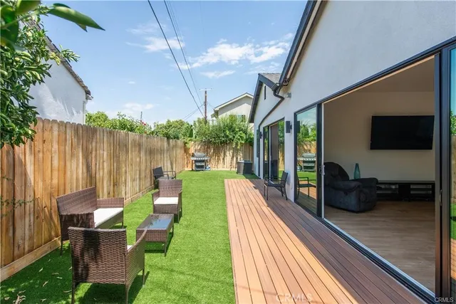 a view of a chairs and table in patio with a backyard