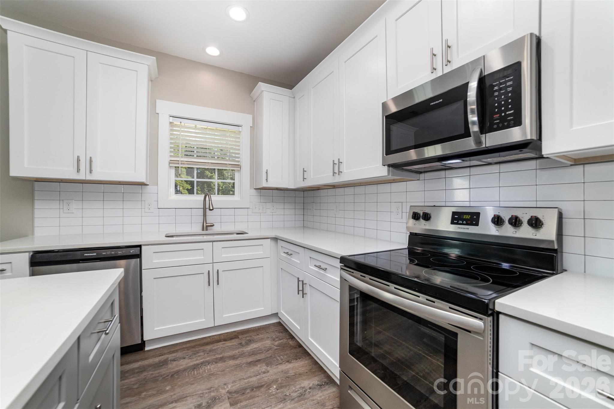 1003 Hunter Valley Road Shelby, NC 28150 - Photo 7 of 23 a kitchen with stainless steel appliances granite countertop grey cabinets a stove a sink and dishwasher