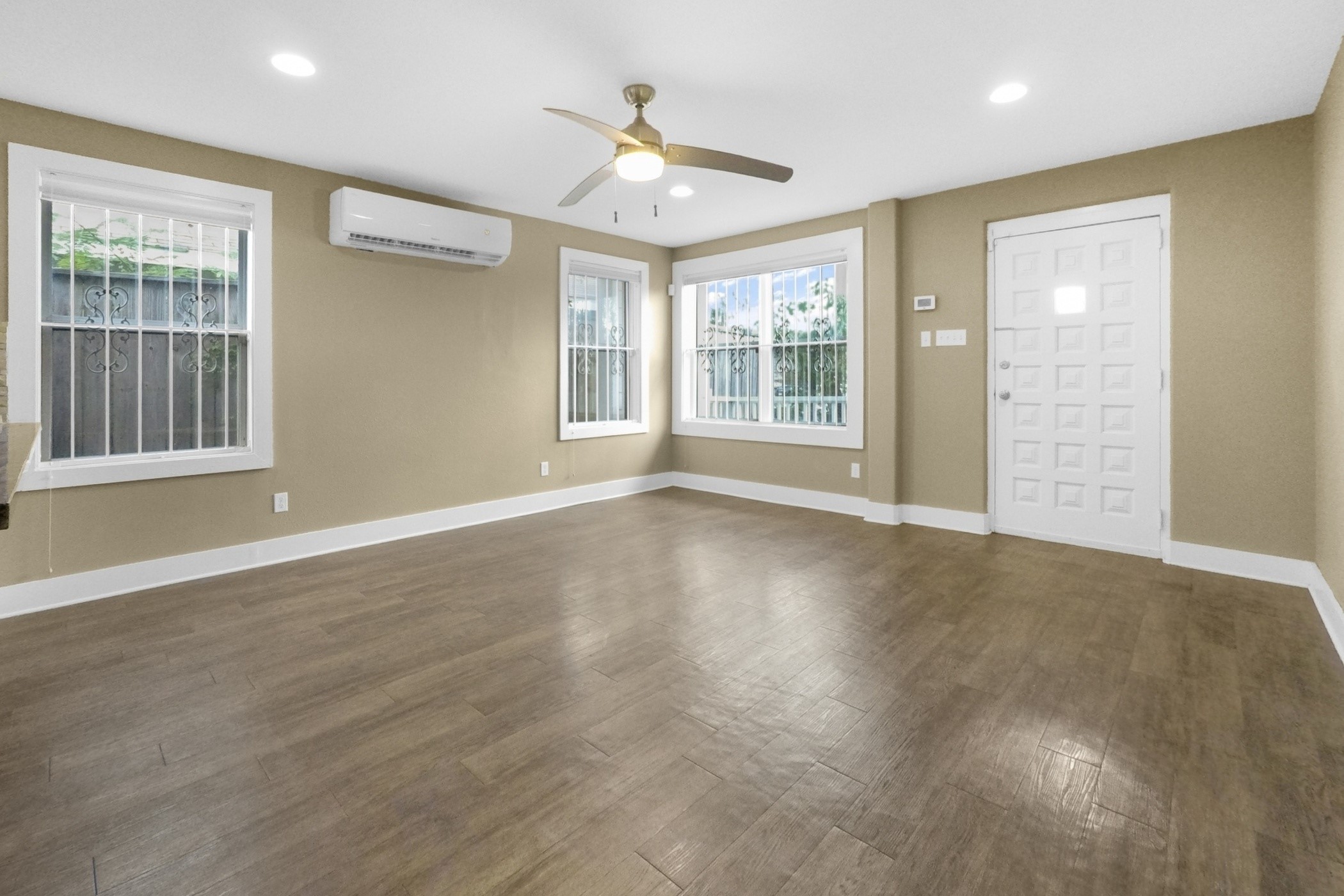 1709 Dan Street Houston, TX 77020 - Photo 11 of 29 a view of an empty room with a window and wooden floor