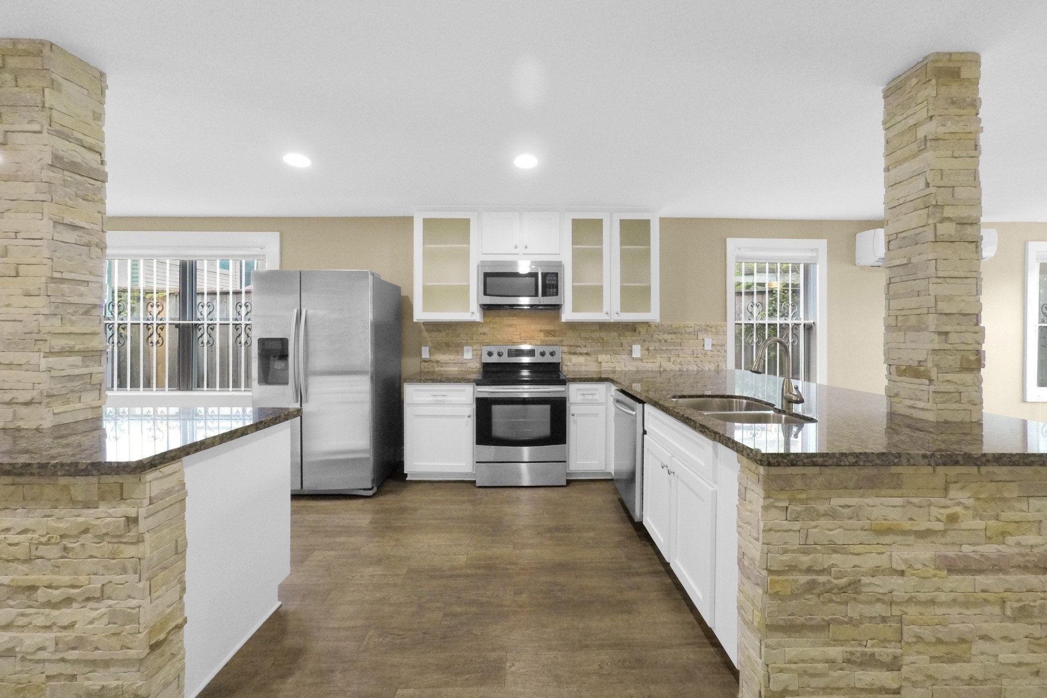 1709 Dan Street Houston, TX 77020 - Photo 13 of 29 a large kitchen with stainless steel appliances kitchen island granite countertop a stove and a sink