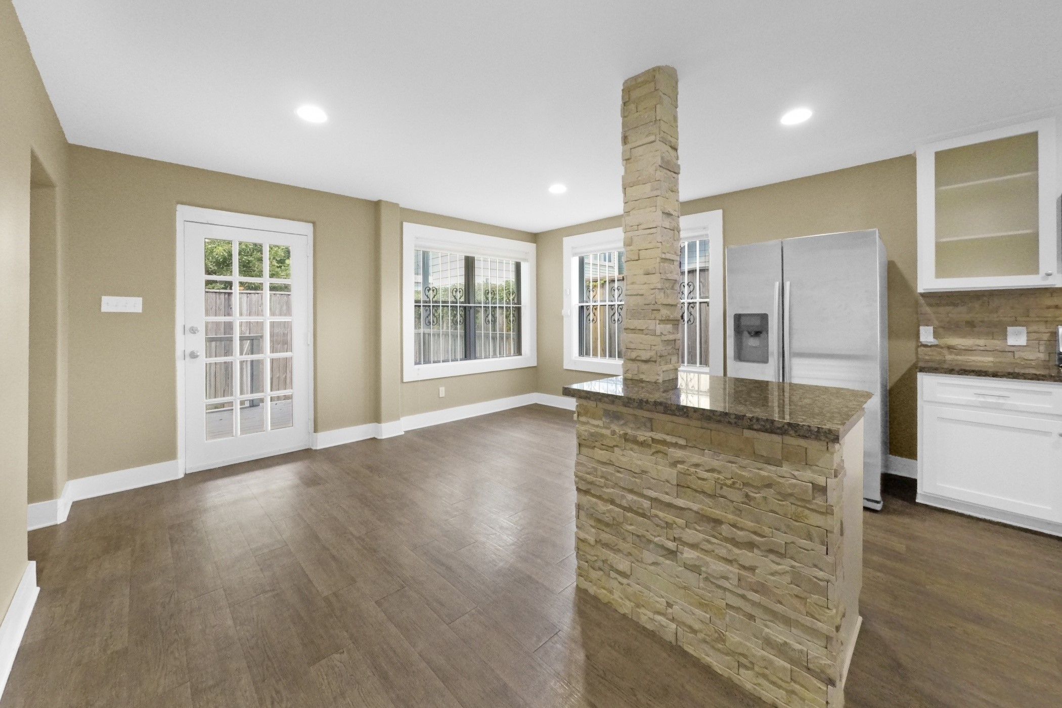 1709 Dan Street Houston, TX 77020 - Photo 15 of 29 an empty room with wooden floor and outdoor kitchen
