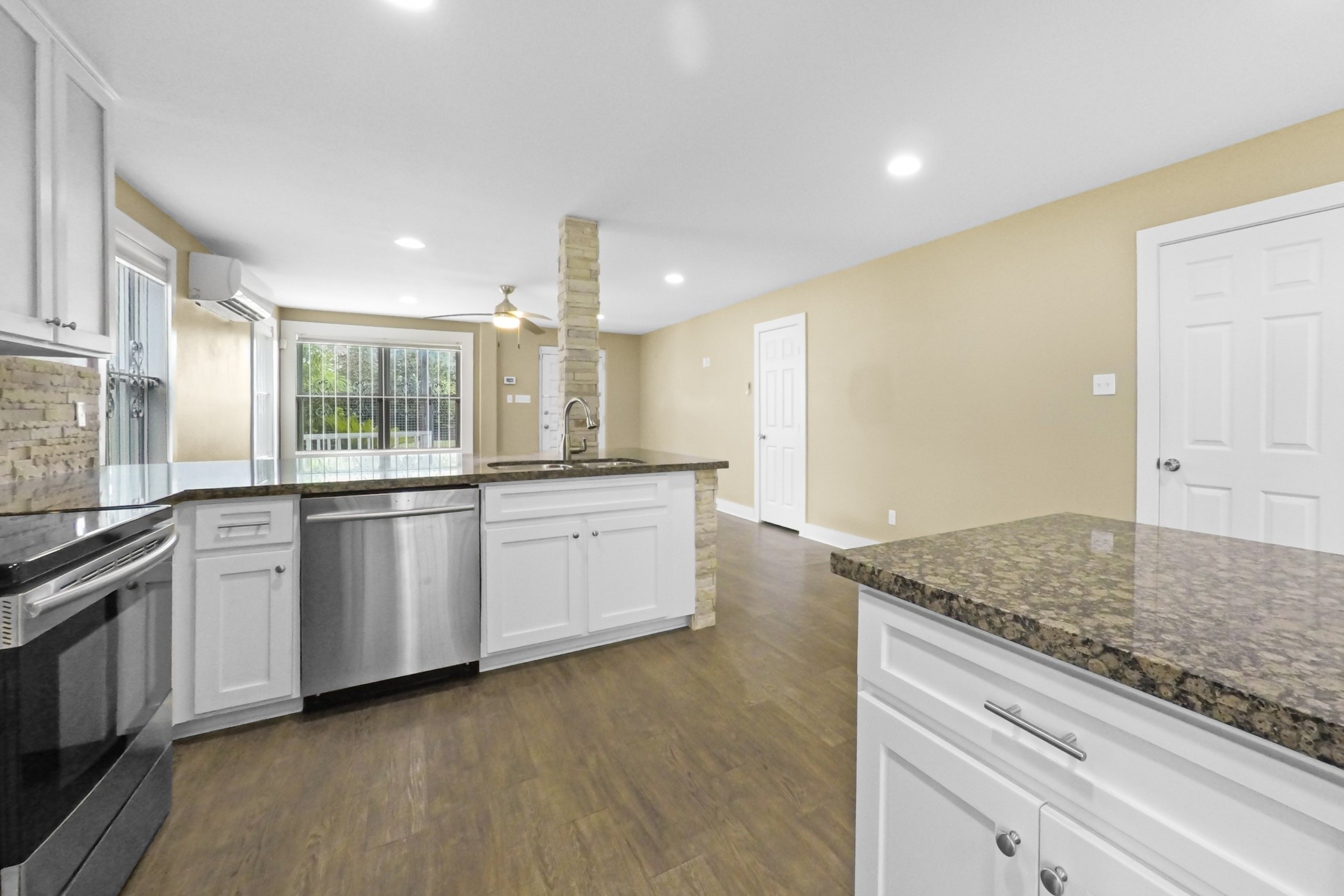1709 Dan Street Houston, TX 77020 - Photo 18 of 29 a large kitchen with granite countertop a sink and white cabinets