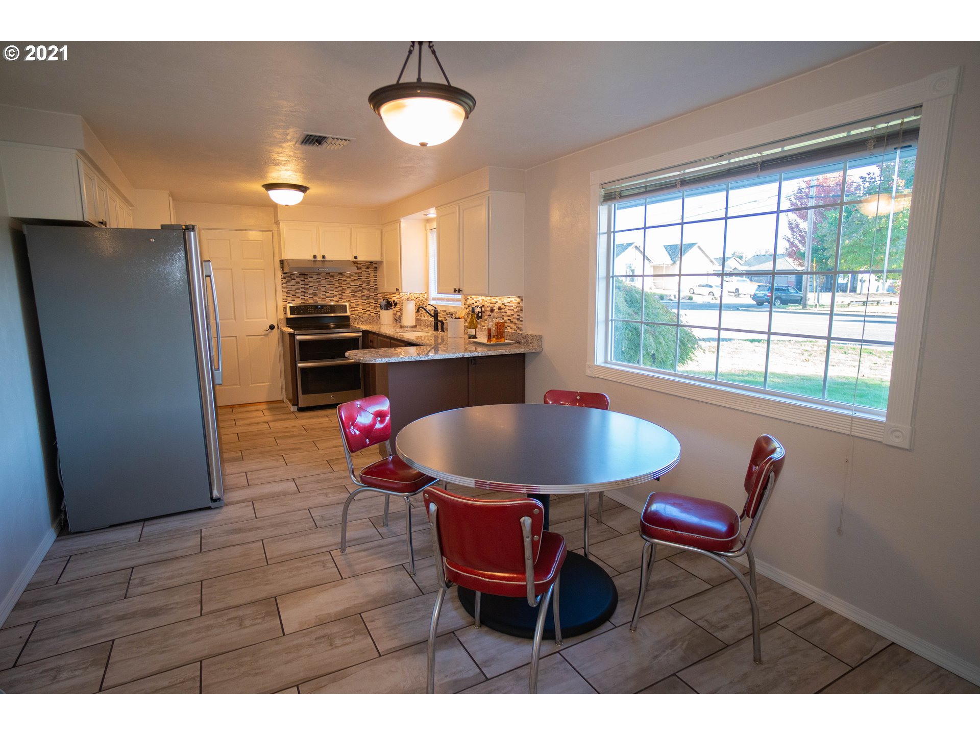 3950 Jasper Road Springfield, OR 97478 - Photo 3 of 20 a living room with dining table and a refrigerator